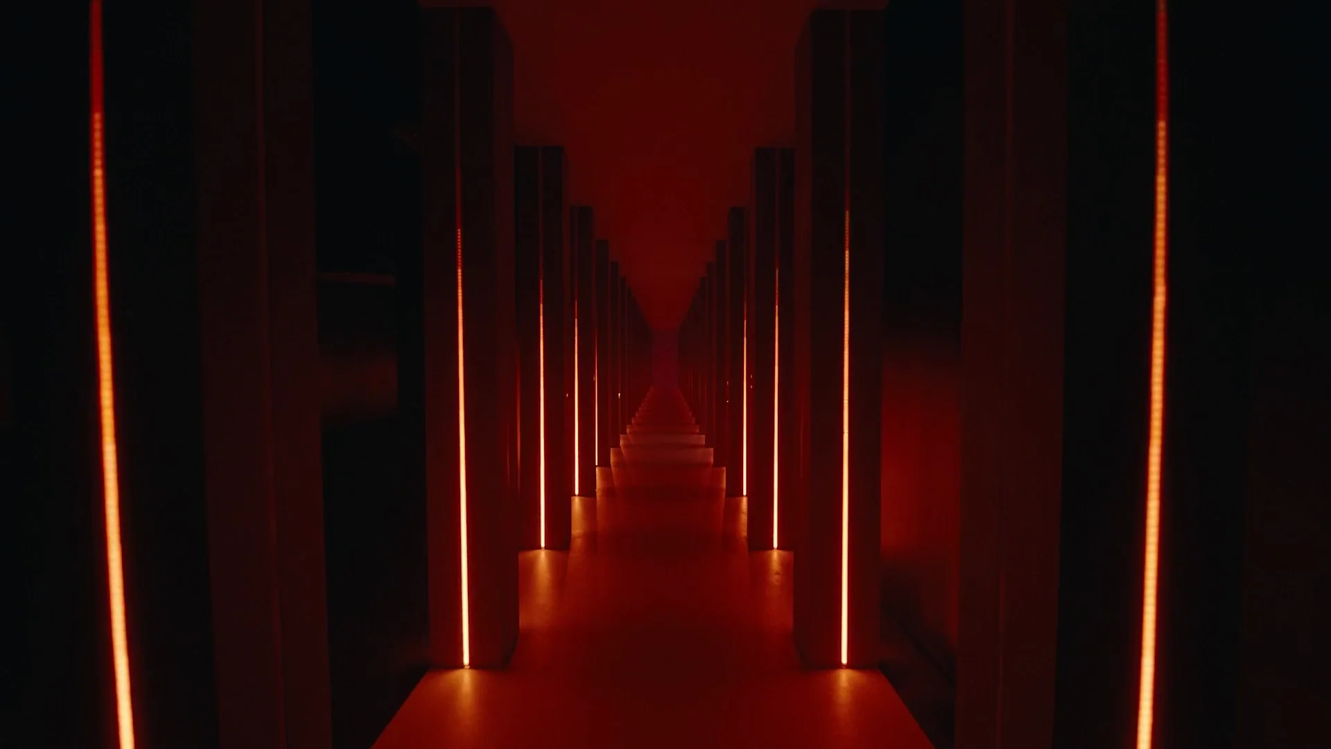 Immersive corridor of illuminated red columns