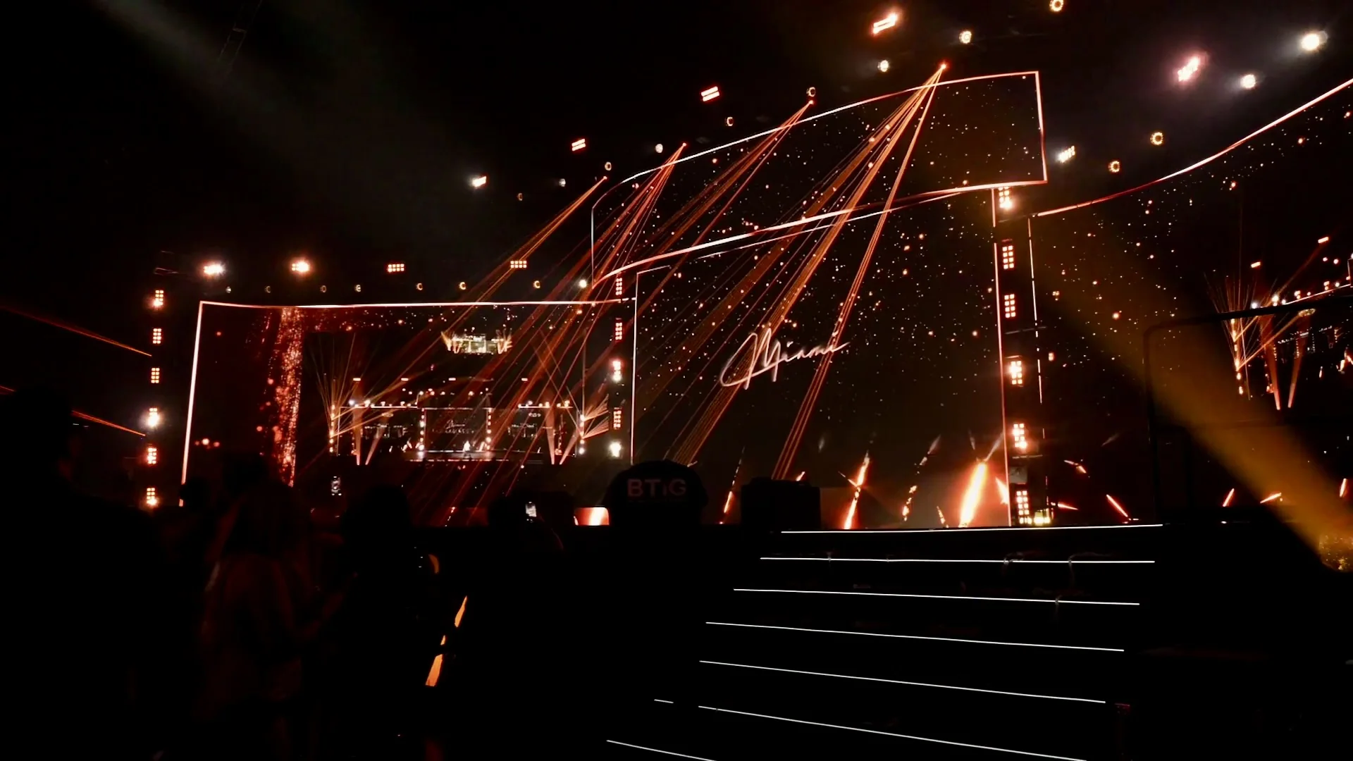 Large event stage with red laser beams and LED screens