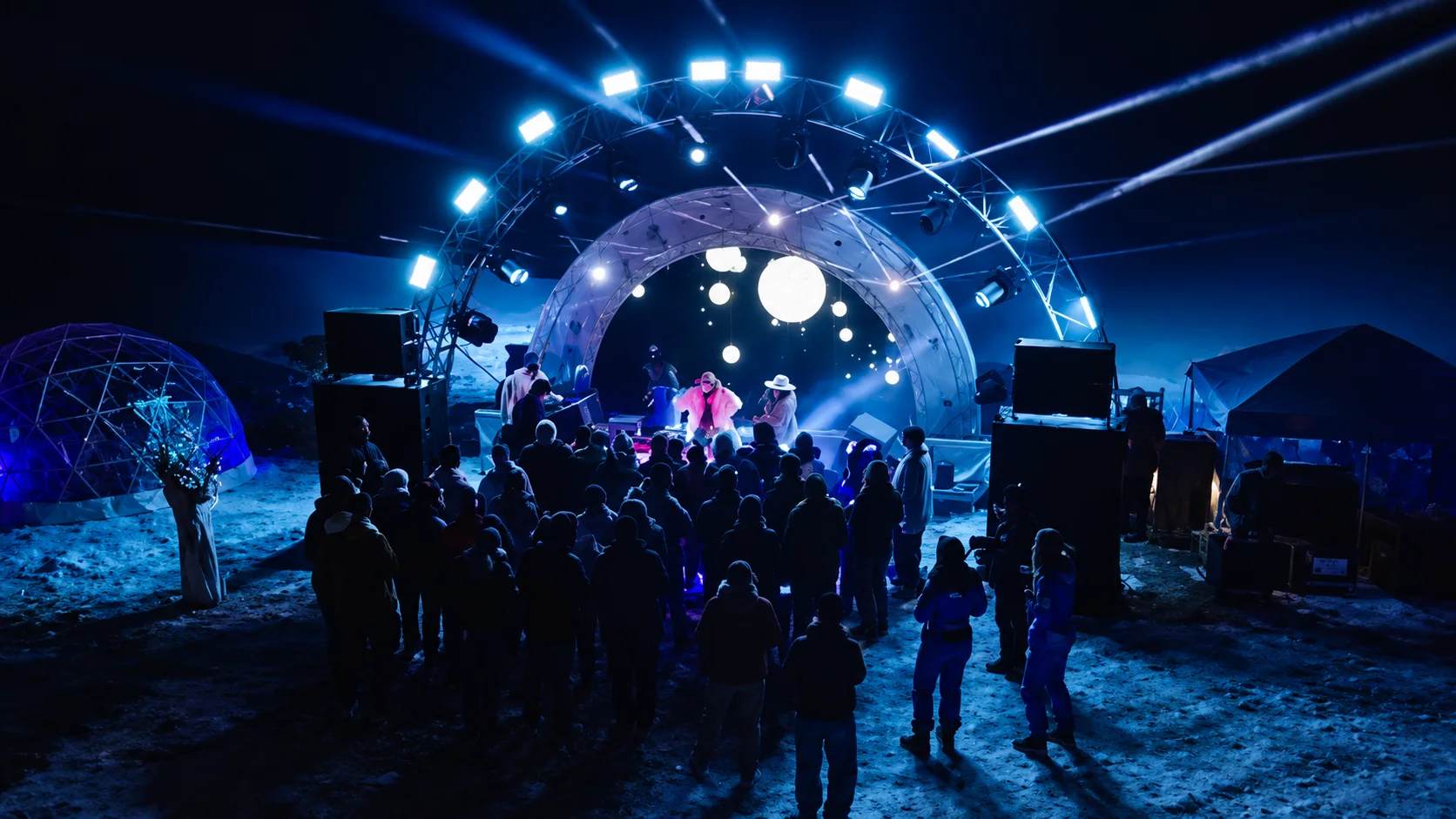 Outdoor performance beneath an illuminated circular stage arch