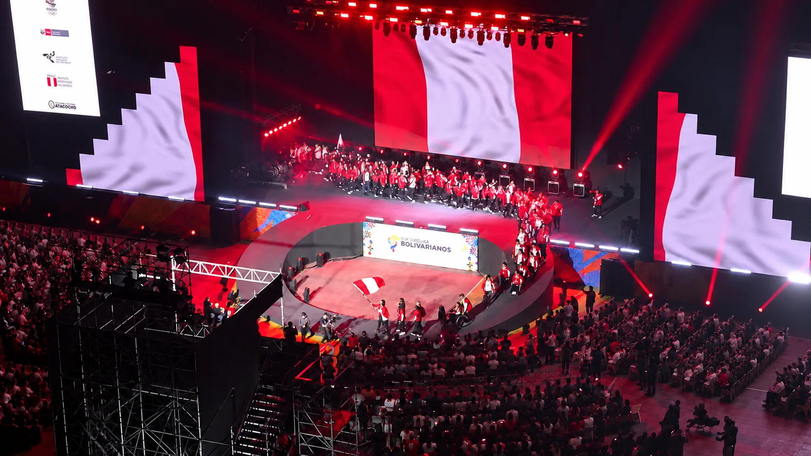 Ceremony with a Peruvian flag on a large stage screen